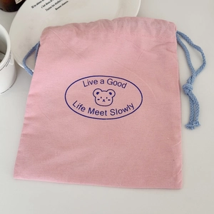 Pink drawstring storage bag with bear print and Live a Good Life text design