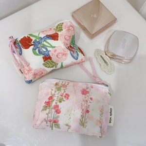 Detail of pink floral cotton mini pouch with zipper and simple wish label