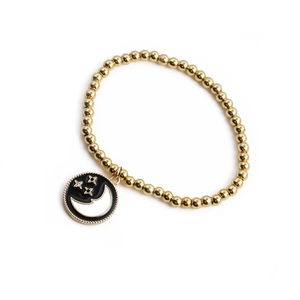 Bracelet perlé plaqué or avec pendentif circulaire en émail motif étoile et lune