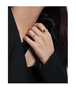 Close-up of S925 silver ring with lava texture and purple zircon on a model hand