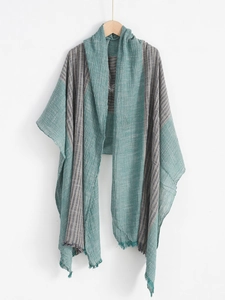 Detail shot of navy blue striped cotton-linen scarf with elegant fringe texture