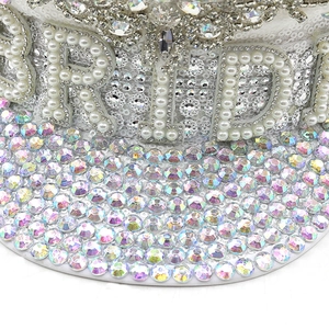 Detail of white sequined captain hat with pearl BRIDE text and sparkling AB rhinestones