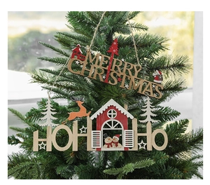 Detail of wooden Merry Christmas and Ho Ho Ho signs hanging on a lush green Christmas tree