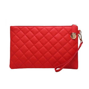 Detail of red quilted faux leather clutch with gold hardware and matching wristlet strap