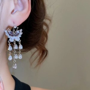 Close-up of elegant purple butterfly tassel earrings with zircon waterdrop pendants