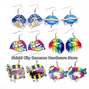 Detailed view of six artistic acrylic lip earrings featuring colorful pop art designs