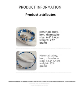 Detailed specs of snake-shaped silver bracelet with blue stripes and green rhinestone eyes
