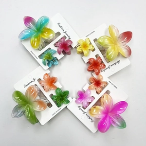 Detailed macro view of plumeria hair claw clips in colorful marble resin gradient sets