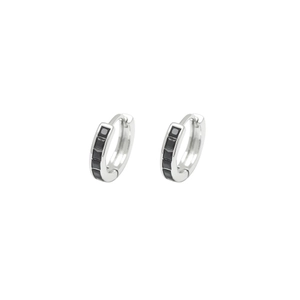 Macro detail of silver hoop earrings featuring five square black cubic zirconia stones