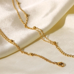 Macro detail of 18K gold-plated stainless steel bead chain with secure lobster clasp