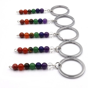 Detail of five chakra keychains with seven colorful natural stone beads and silver ring