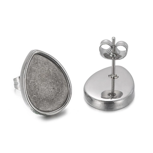 Detailed view of silver teardrop stud earrings with textured inlay and earring posts