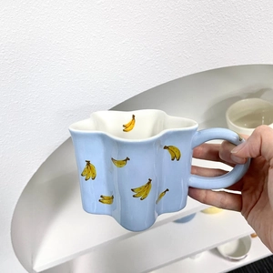 Handheld blue ceramic star cherry mug with hand-painted banana pattern for coffee and milk