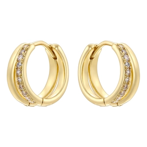 Macro shot of gold-plated hoop earrings featuring inlaid white cubic zirconia crystals