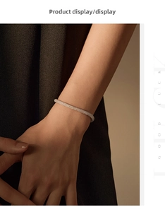 Close-up of sparkling S925 sterling silver mesh bracelet on a woman wrist in soft light