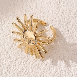 Macro shot of a vintage gold sun ring featuring intricate facial details and adjustable band