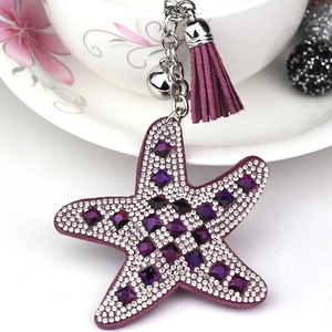 Close-up of purple starfish keychain with sparkling rhinestones and matching tassel
