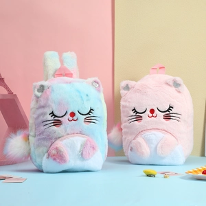 Detail view of plush cat backpacks in rainbow tie-dye and pink with glitter heart ears