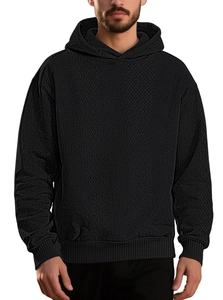 Men's black pullover hoodie with jacquard knit texture and ribbed cuffs for spring
