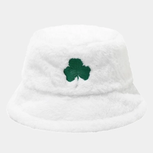 Close-up of green clover embroidery on soft white plush bucket hat with fluffy texture