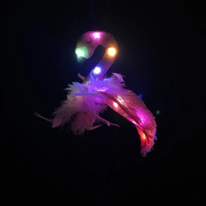 Detail of pink flamingo headband with fluffy feathers and glowing multi-color LED lights