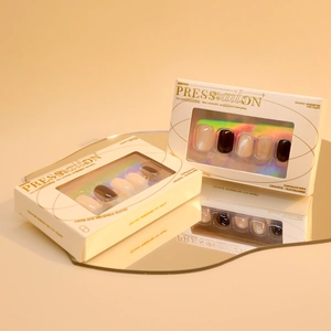Short round cat eye press-on nails in black and nude pink with premium gold foil packaging