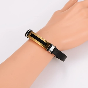 Men's minimalist black leather bracelet featuring a gold metal plate and black enamel inlay