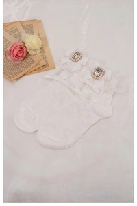 Detail of white Lolita socks featuring ribbon bows with square rhinestones and pearls