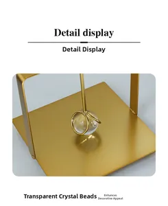 Detail view of the modern gold metal base with a clear crystal bead on the napkin holder