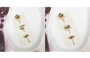 Detailed view of three polished gold alloy hair clips on a white ceramic plate