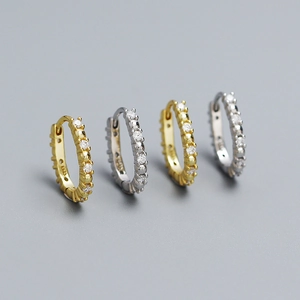 Macro shot of S925 sterling silver U-shaped huggie earrings with cubic zirconia inlay