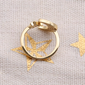 Macro detail of gold adjustable open ring featuring celestial moon and star design