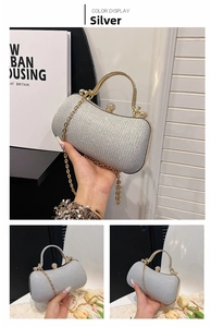 Silver evening clutch bag with sparkling sequin texture and golden ring handle detail