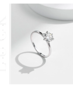Detailed view of six-prong moissanite engagement ring with S925 sterling silver hallmark