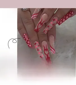 Detail of long French Valentine's Day press-on nails with red heart flames and rhinestones