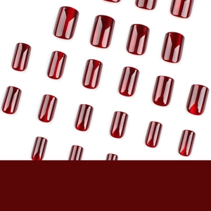 Short square red cat-eye press-on nails with glossy finish on a clean white background