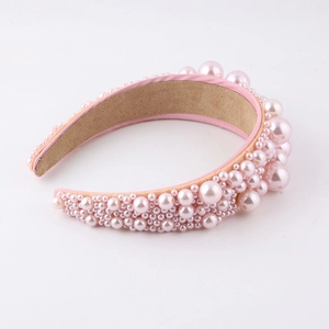 Elegant wide headband with multi-sized pink imitation pearls on a soft fabric base