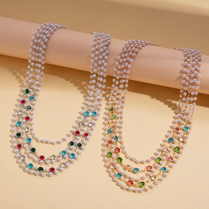 Baroque layered pearl sweater necklace with multi-colored crystals on beige display stand