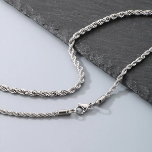 Macro shot of silver titanium steel rope chain with secure lobster clasp on slate stone