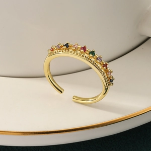 Golden adjustable ring with multi-color zircon stones on white ceramic holder