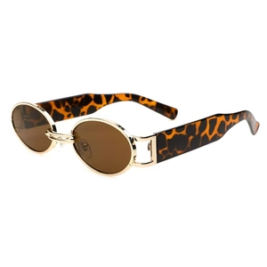 Macro detail of oval vintage sunglasses with gold frame and leopard pattern temple