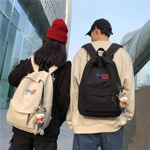 Outdoor shot of the minimalist backpack with China embroidery and cow charm detail