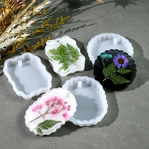 DIY silicone molds for resin casting featuring geometric shapes with dried flower inserts