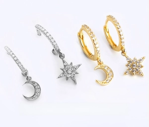 Macro detail of S925 sterling silver star and moon earrings with sparkling zircon inlay