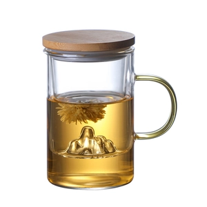 Glass tea cup with wooden lid, yellow handle and mountain design filter on white background