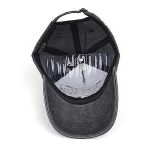 Detail view of cotton baseball cap interior showing sweatband and adjustable metal strap
