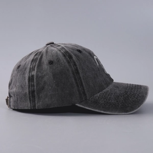 Detail view of washed gray cotton baseball cap with vintage metal adjustment buckle
