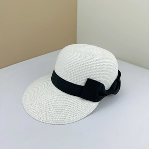 Women's woven straw sun hat in cream white featuring a wide decorative black ribbon bow