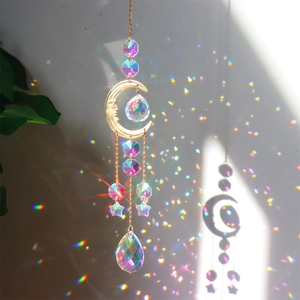 Detailed view of golden crescent moon crystal suncatcher reflecting rainbow light spots