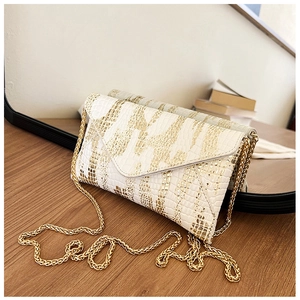 Detail of white and gold crocodile pattern envelope bag with elegant golden chain strap